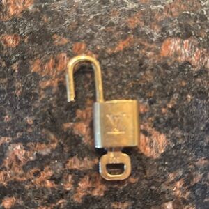 Authentic LV lock and key set #302. Gold -tone vintagege. Pre-owned